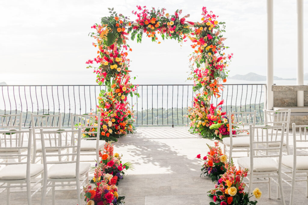 tropical flower arch and aisle for a destination wedding